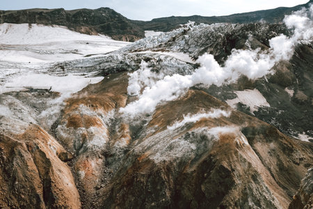 View of mountains and volcanoes from the edge of the craterの写真素材