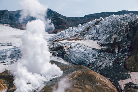 View of mountains and volcanoes from the edge of the crater