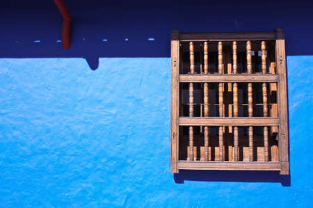 window and wal in blue. House in the spanish colonial neighborhood of La Candelaria, Bogota, Colombiaの写真素材