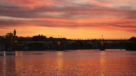 Dusk in the Guadalquivir. Triana Bridge, Seville, Andalucia, Spainの写真素材