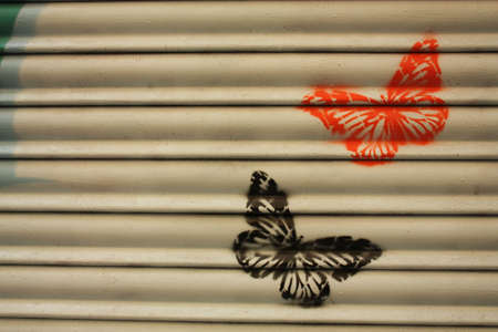 Drawings of butterflies in a metal fenceの写真素材