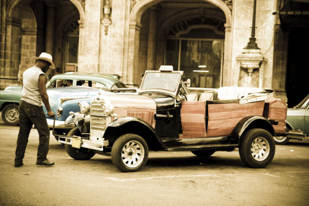 Havana, Cuba - September 9, 2011: A driver turns on an old car in the streets of Havana. Ancient light. Havana, Cuba. Cubans, unable to buy newer models, keep thousands of them running.Ford A, 1930 model.のeditorial素材
