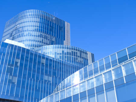 Modern office building with blue glass facade futuristicの写真素材