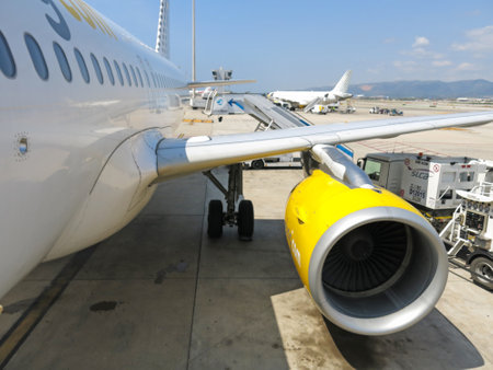 BARCELONA- AUGUST 5: Airbus A320 of the Vueling Airlines receiving fuel from tanker truck at Barcelona International Airport on August 5, 2014 in Barcelona, Catalonia, Spain.のeditorial素材