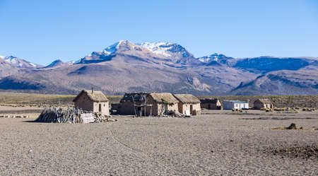 Small village of shepherds of llamas in the Andean mountains. High Andean tundra landscape in the mountains of the Andes. The weather Andean Highlands Puna grassland ecoregion, of the montane grasslands and shrublands biome,の写真素材