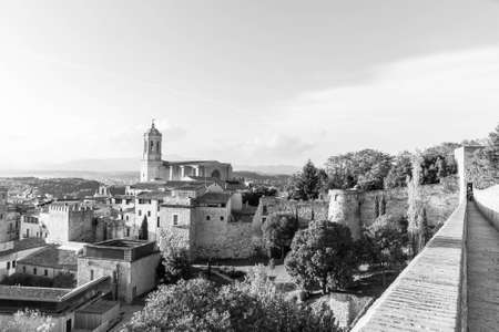 The medieval quarter of Gerona with bell tower of Santa Maria cathedral in background. View from The Forca Vella. Gerona, Costa Brava, Catalonia, Spain. Monochrome image: black and white.の写真素材