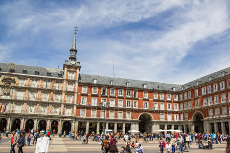 MADRID, SPAIN - APRIL 22, 2012: Tourists visiting Plaza Mayor in Madrid, Spain. The Plaza Mayor (English Main Square) is a central plaza in the city of Madrid. It is located only a few Spanish blocks away from another famous plaza, the Puerta del Sol.のeditorial素材