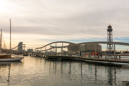 BARCELONA - MAR 1: Sunrise at the port of Barcelona, at the end of the Ramblas on March 1, 2017 in Catalonia, Spain. In the photo, the Ramblas on the sea, the World trade center building and the funicular tower.のeditorial素材