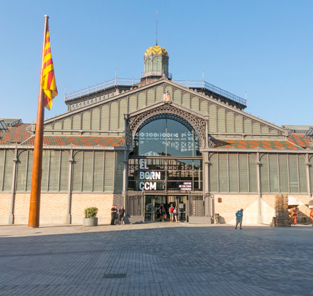 BARCELONA, SPAIN - JUNE 1, 2017: The facade of Born market, and flag of Catalonia. It is an example of iron architecture, a movement within the modernist. Born district. Barcelona, Catalonia, Spainのeditorial素材