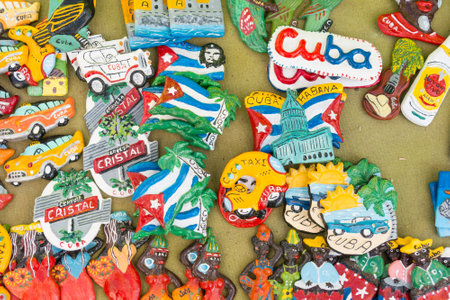 CIENFUEGOS, CUBA - JANUARY 3, 2017: Cuban national flags, palm, Che Guevera portraits and other fridge magnet / souvenirs typical for Cuba sold in souvenir shop in street market in Cienfuegos, Cubaのeditorial素材