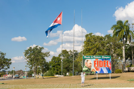 SANTA CLARA, CUBA-JANUARY 6, 2017: Poster with image of Fidel Castro and Cuban flag in the Plaza de la RevoluciÃ³n in the city of Santa Clara, Cuba. Next is the Mausoleum of homage to Ernesto Che Guevara.のeditorial素材