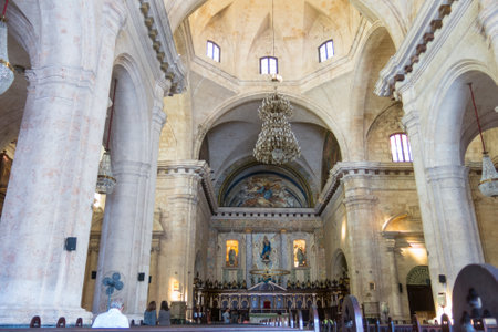HAVANA, CUBA - JANUARY 16, 2017: Interior of Old Havana Catholic Cathedral. The hall has stone pillars, high roof, and rows of benches going til the far end.のeditorial素材