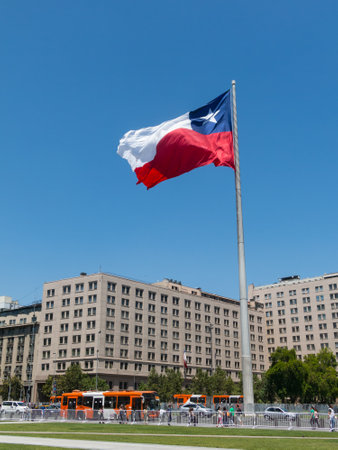 SANTIAGO DE CHILE, CHILE - JANUARY 26, 2018: Chileans walking near the giant flag on Avenida La Alameda with the citizenship Square, in downtown Santiago de Chile. Chile.のeditorial素材