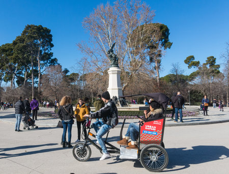 Madrid, Spain - January 27, 2018: Fountain of Fallen Angel (Fuente del Angel Caido, by Ricardo Bellver, 1877) - highlight of Buen Retiro Park. Buen Retiro Park - Park of Pleasant Retreat - one of largest parks of Madrid City. Spain.のeditorial素材