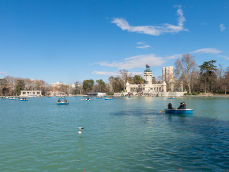 Madrid, Spain - January 27, 2018: People enjoying a boat ride on the pond in El Retiro Park in Madrid, Spain. El Retiro is the largest park of the city of Madrid. Spain.のeditorial素材