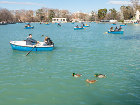 Madrid, Spain - January 27, 2018: People enjoying a boat ride on the pond in El Retiro Park in Madrid, Spain. El Retiro is the largest park of the city of Madrid. Spain.のeditorial素材