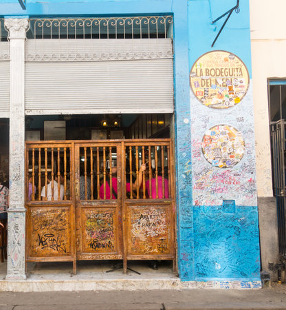 HAVANA, CUBA - JANUARY 16, 2017: Bar La Bodeguita del medio, on Obispo street. Tourists walking in a daily scene in Old Havana, on a sunny day. Havana, Cubaのeditorial素材