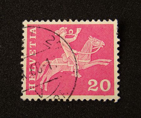 Helvetia (Switzerland) postage stamp on black background.               の写真素材