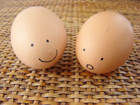 Happy and surprised eggs friendship on rattan background