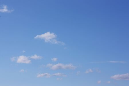 Blue sky background with cloudsの写真素材