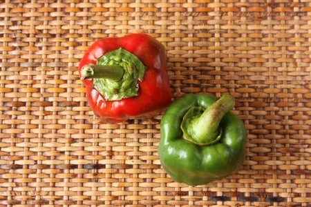 Fresh baby peppers over rattan boardの写真素材