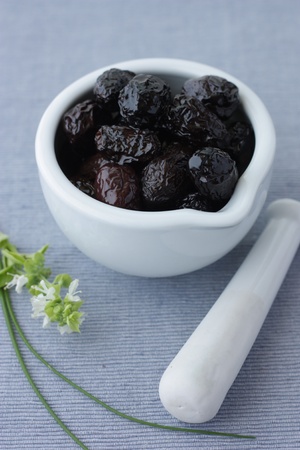 Still life with greek olives on mortar (soft focus)の写真素材