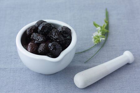 Still life with greek olives on mortar (soft focus)の写真素材