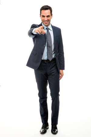 Full length portrait of a businessman smiling and pointing finger while walkingの写真素材