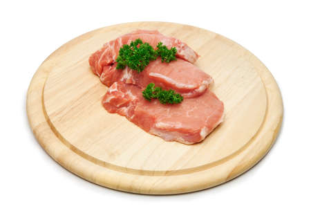 Fresh raw pork steak meat on wooden board.の写真素材
