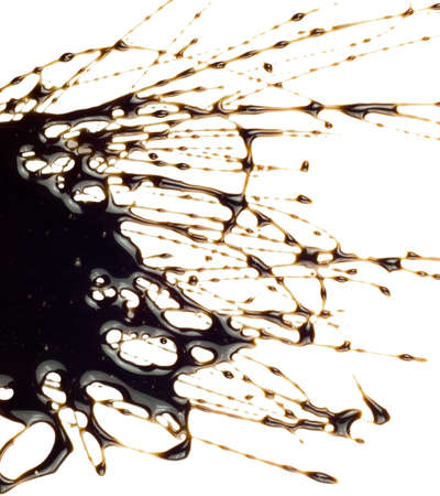 Chocolate syrup leaking on white backgroundの写真素材