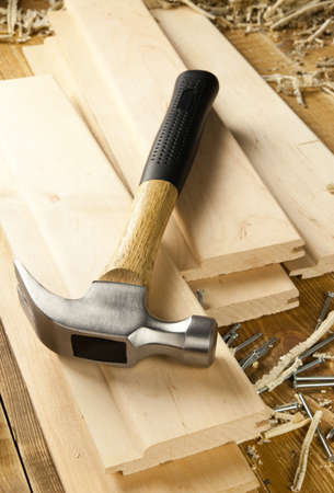 Hammer and nails are on a wooden planks の写真素材