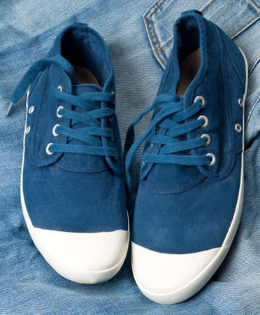A pair of new blue shoes on a jeansの写真素材