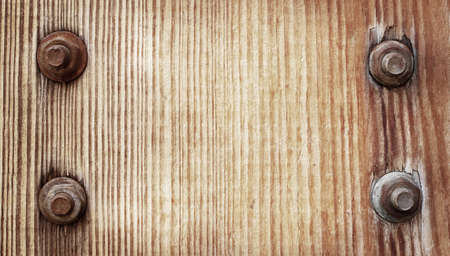 Old grunge brown wooden texture with metal screwの写真素材