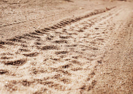 car tire track in gravel
