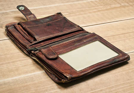 Opened old purse on wooden tableの写真素材