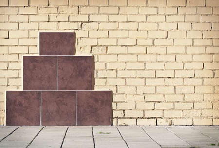 Brick grunge weathered wall background with walkwayの写真素材