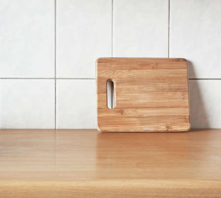Brown cutting bamboo board for cooking on the tableの写真素材