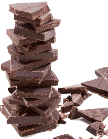 Dark chocolate bars stack with crumbsの写真素材