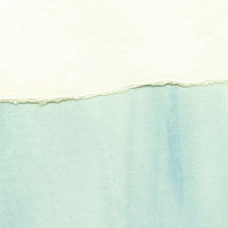 Painted watercolor background on torn paperの写真素材