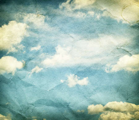 Vintage clouds and sky on crumpled paper texture.の写真素材