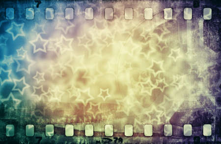 Grunge scratched colorful film strip background with starsの写真素材