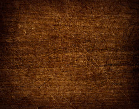 Dark scratched grunge cutting board, table desk or floor surface. Wooden texture.の写真素材