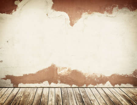 Stuccoed concrete wall with grunge wooden floor.