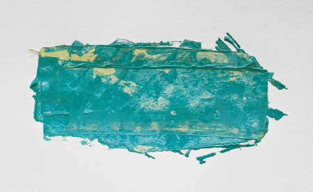 Turquoise watercolor acrylic painting with brush on white paper.