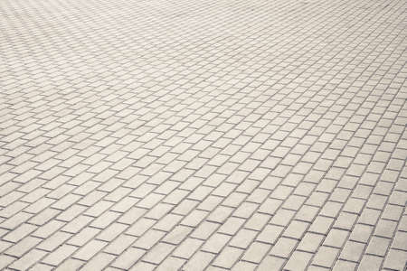 Brown brick stone street road. Light sidewalk, pavement textureの写真素材