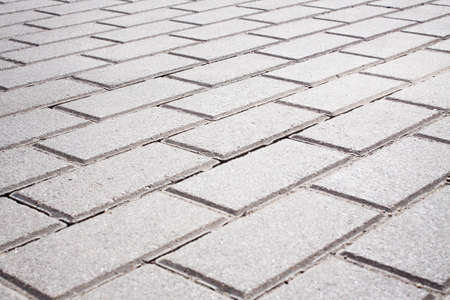 Grey brick stone street road. Light sidewalk, pavement textureの写真素材