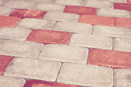 Red brick stone street road. Light sidewalk, pavement texture.の写真素材