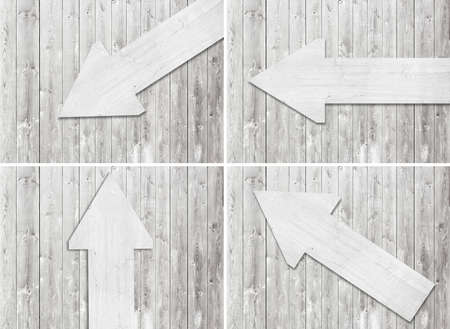 Set of white scratched wooden arrow are on wall.の写真素材