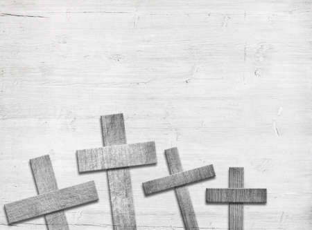 Wooden cross on brown old table top.の写真素材