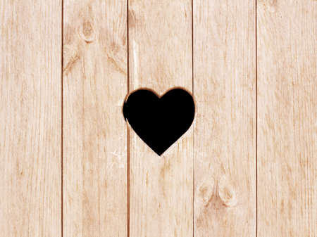 Heart shape cut on wooden wall, toilet, wc door or window.の写真素材